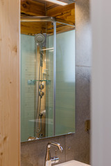 Details of a modern shower cubicle in a bathtub.