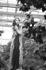  stunning black and white portrait beautiful  young model girl in arranger where azalea blooms in a flying dress.  Beauty and Fashion