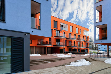 Colorful Modern residential apartment and flat building exterior in Salzburg, of Austria. New luxury house and home complex of blue and red color. City Real estate property and condo architecture.