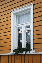 Lappeenranta, Finland. Christmas street. Christmas decoration. Winter street and old yellow buildings in the fog on the territory of the fortress. window in white frame