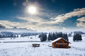 Fairy-tale winter landscape and cottage in woods at winter. Christmas concept.