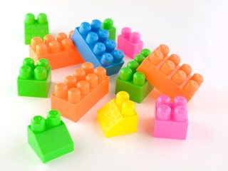 blocks of children’s designer of different shapes and colors on a white background