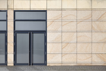 Front view of a building wall with closed door.