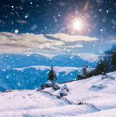 Winter postcard of cottage in the mountains at sunrise. Christmas concept.