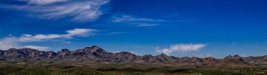 Sunset, aerial landscapes of Santa Rita Mountains from above Tubac, Arizona with warm , golden plains, purple mountains, blue sky with colorful clouds on a Fall day 