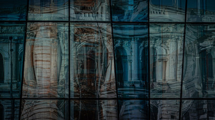 Reflection of ancient architecture in the windows of the modern building
