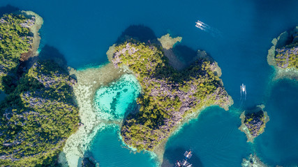 Aerial view on turquoise lagoon with boats around