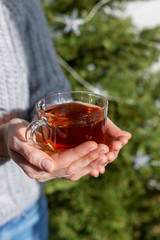 Close up tea cup in girl's hands