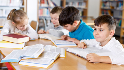 Children studying in school library