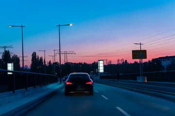 A driving car on a road, driving car at dusk, sunset, colorful, evening, cars