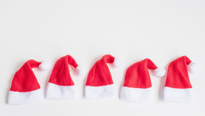 five caps of Santa Claus on a white background