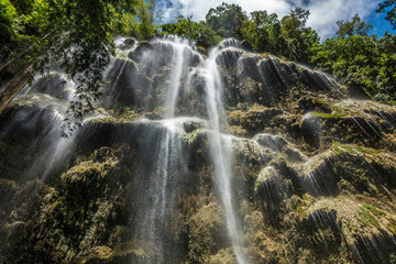 Fototapeta na wymiar Under the amazing waterfall in a rain forest 