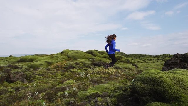 Fitness Athlete trail runner - running woman exercising. Fit female sport fitness model training jogging outdoors living healthy lifestyle in beautiful nature, Iceland. Shot on RED.