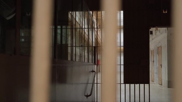 view of the prison corridor through the bars.