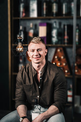 handsome sexy man at the bar counter in a shirt.