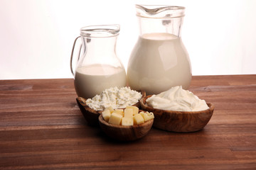 Different  healthy dairy products on rustic background with milk, cheese, butter and cottage
