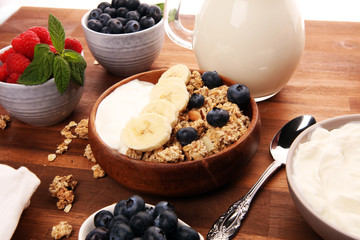 Tasty homemade granola served on table. Healthy breakfast with a bowl of oatmeal with banana, blueberries, strawberries and healthy food for Breakfast