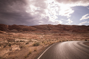 Desolate Desert road with mountains; Western United States