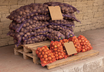 Bags with potatoes and onions for sale concept