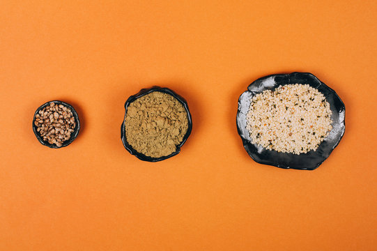 Different types of uses for hemp. Seeds, protein and powder in ceramic bowls.