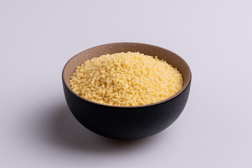 Dry couscous isolated on white background, soft light, copy space.