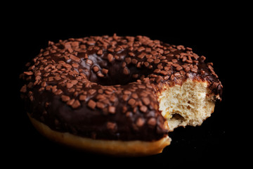 Chocolate donuts decorated with colorful sprinkles
