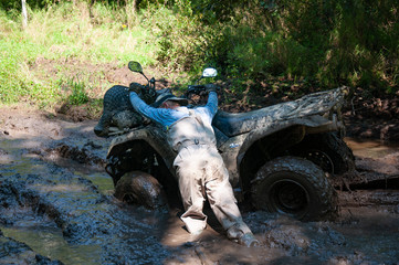 Fototapeta na wymiar ATV wheels in the mud while overcoming a difficult section.