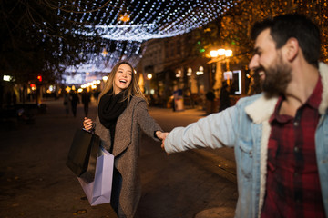 Close up of a young couple shopping in the city at night