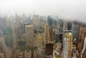 Fototapeta na wymiar Top view of New York skyline in rainy and cloudy day. Skyscrapers of NYC in the fog