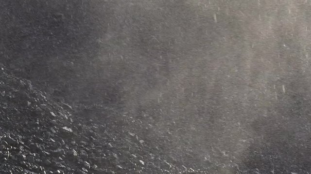 Coal heap close up. Pour drops of water onto a coal pile. Rain at the coal terminal.