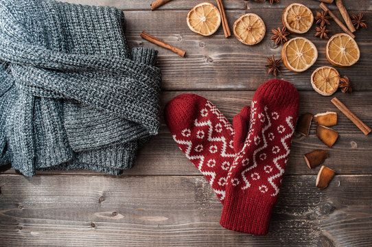 winter flatlay with cozy home sweater, mittens and spices for mulled wine