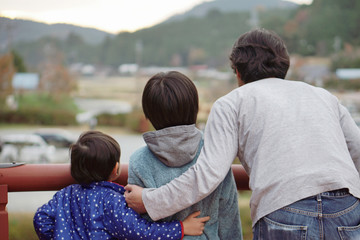 Father and sons looking at mountains view. Concept for friendship, future and discovery .