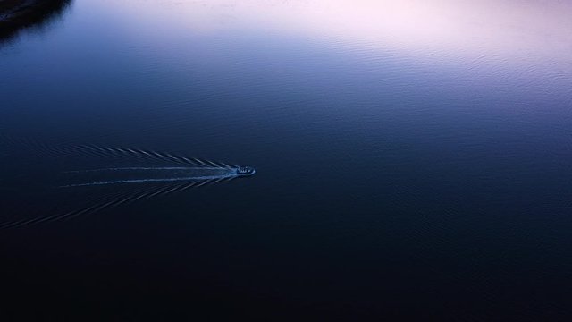 aerial footage of loch linnhe at port appin on the west coast of scotland in the argyll region of the highlands near oban and fort william on a pink sunset evening in winter with calm seas