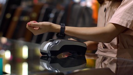 Young woman smart watch contactless payment in shop