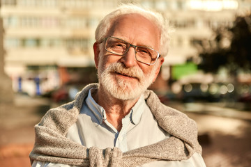 Life is beautiful. Portrait of happy and handsome bearded senior man in glasses looking at camera...