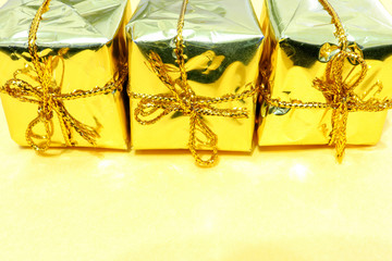 Christmas decorations fir cones gift boxes tinsel on yellow background macro