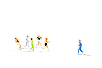 Fototapeta premium Business Leader and Teamwork Concept : Miniature people as alone runner jogging opposite direction with mass of other runners isolated on white background.