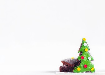 Christmas tree composition, homemade green gingerbread cookies Christmas tree shape, colorful sprinkles decorated on white background, holiday sweet brownie cake dessert in party, copy space