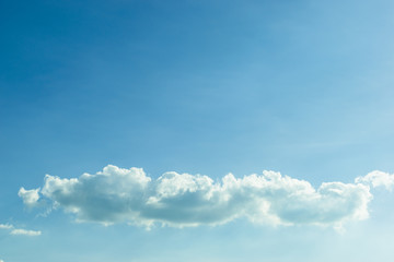 Naklejka na ściany i meble fluffy cloud above clear blue sky