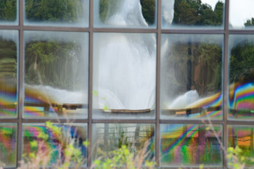fountain reflection in colorful windows