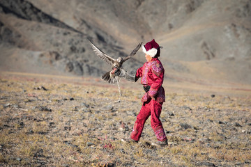 Young eagle hunters start training with falcons from early age. Series of a young boy catching his...