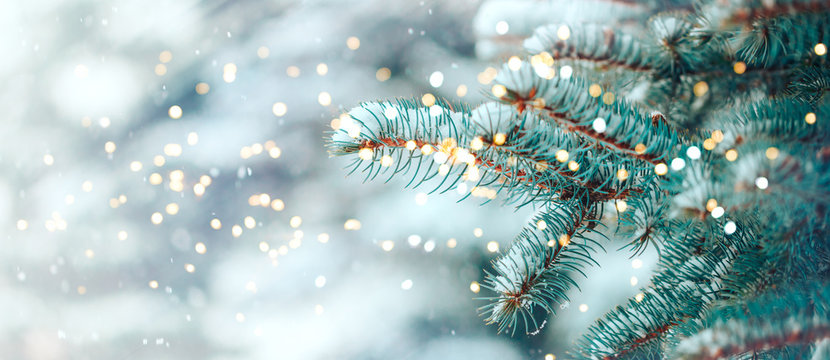 Christmas tree outdoor with snow, lights bokeh around, and snow falling, Christmas atmosphere.