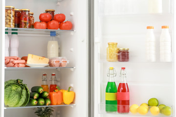 Fototapeta na wymiar Different products on shelves in fridge