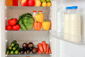 Fototapeta na wymiar Different products on shelves in fridge