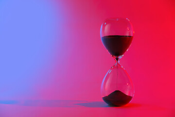 Crystal hourglass on color background