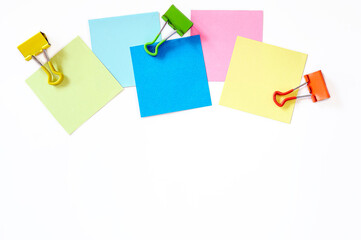 colorful sticky note and paper clip on white background, top view  and copy space.