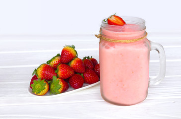 Strawberry yogurt fruit juice smoothie pink colorful fruit juice milkshake blend beverage healthy high protein the taste yummy In glass drink episode morning on white wood background.