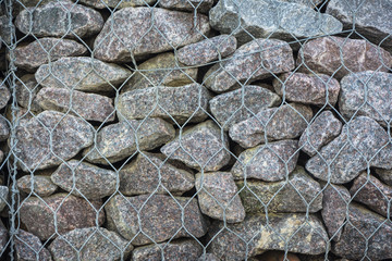 stones and pebbles wall in wire mesh