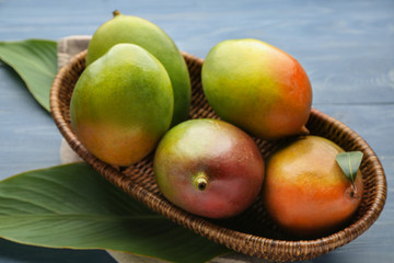 Basket with mango fruit on table