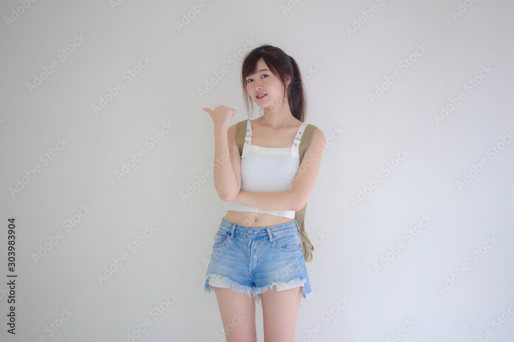 Wall mural beautiful thai girl tourists scottish white shirt blue jeans pointing